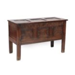 An Early 18th Century Joined Oak Chest, the hinged lid with three moulded panels above a lunette