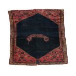 Rare Malayir Saddle Rug, circa 1910 The deep indigo lozenge field with central boat shaped panel