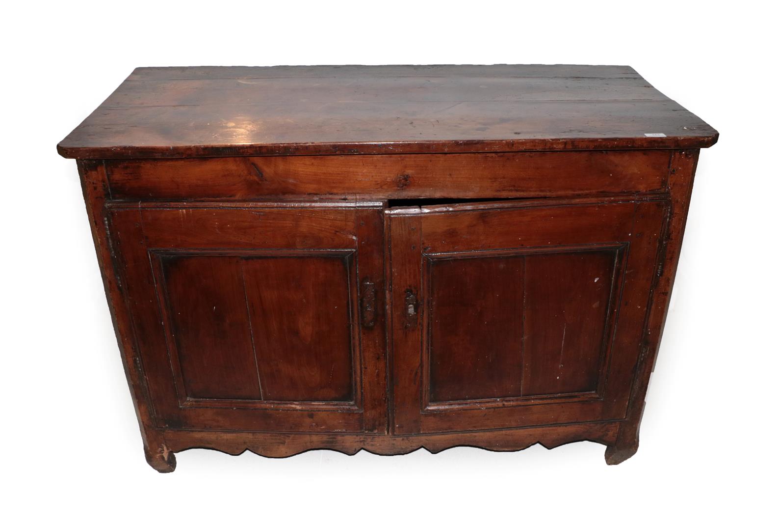 An Early 18th Century French Provincial Fruitwood Sideboard, the canted rectangular top above two