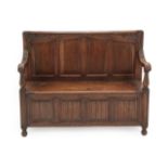 A Carved Oak Box Settle, circa 1900, the back support with acanthus scrolls and four moulded