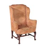 A George III Style Wing-Back Armchair, probably early 19th century, covered in close-nailed pink