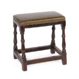 An Oak Joint Stool, with later close-nailed green leather overstuffed seat, on baluster turned