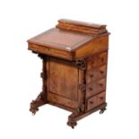 ~ A Victorian Figured Walnut and Crossbanded Davenport, circa 1870, the moulded top with hinged