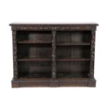 A Victorian Carved Oak Free-Standing Bookcase, 3rd quarter 19th century, with stiff leaf carved edge