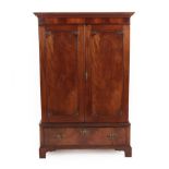 A Late George III Mahogany Dwarf Linen Cupboard, early 19th century, the moulded dentil cornice