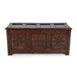 A Late 17th Century Joined Oak Chest, the hinged lid with four moulded panels above a carved