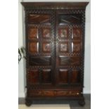 An 18th Century Portuguese Carved Rosewood Armoire, the moulded cornice above a carved frieze,