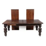 A Victorian Carved Oak Wind-Out Dining Table, circa 1880, with three additional leaves, the carved