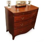A George III Mahogany Bowfront Chest of Drawers, late 18th century, with pull-out brushing slide