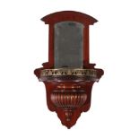 A Mahogany Wall Bracket, late 19th century, the moulded pediment above a bevelled glass plate, the