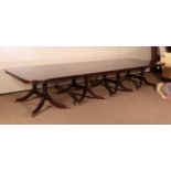 ~ A Reproduction Mahogany Eight Pillar Dining Table, with two additional leaves, on conforming