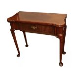 A Mid 18th Century Red Walnut Foldover Tea Table, the eared corners above a frieze drawer, on