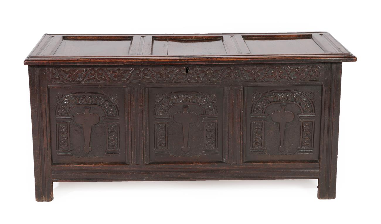 A Late 17th Century Joined Oak Chest, the hinged lid with three moulded panels above a carved frieze