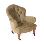 A Victorian Upholstered Armchair, circa 1880, recovered in buttoned green fabric, with overstuffed