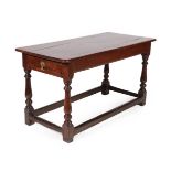 A Joined Oak Refectory Table, with plain frieze, on turned legs with block feet joined by a