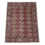 Unusual Oriental Carpet Possibly Tabriz, circa 1950 The raspberry field with columns of diamond