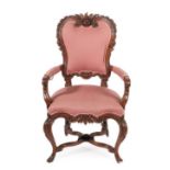 ~ A Late 19th Century Italian Carved Walnut Open Armchair, recovered in pink fabric, the elaborate