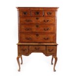 A George II Figured Walnut and Feather-Banded Chest on Stand, mid 18th century, the moulded