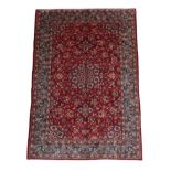 Mashad Carpet North East Iran, circa 1970 The blood red field of vines around a flowerhead medallion