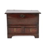 An Early 18th Century Oak Chest, the hinged lid above two small drawers and an arched apron with