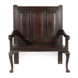 A Joined Oak Two-Seater Settle, mid 18th century, the back support with three fielded panels above