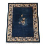 Chinese Carpet, circa 1920 The deep indigo field with central panel containing a dragon enclosed