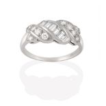 A Diamond Ring, a row of graduated baguette cut diamonds flanked by rows of graduated round