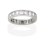 A Diamond Eternity Ring, the twenty round brilliant cut diamonds in white claw and channel settings,