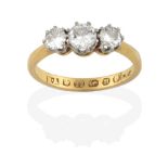A 22 Carat Gold Diamond Three Stone Ring, the graduated round brilliant cut diamonds in white claw