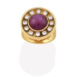 An 18 Carat Gold Ruby and Diamond Cluster Ring, the round cabochon ruby in a yellow rubbed over