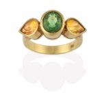 A Green Tourmaline and Yellow Sapphire Three Stone Ring, the central oval cut green tourmaline