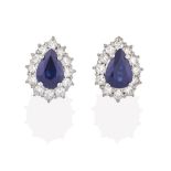 A Pair of Sapphire and Diamond Cluster Earrings, the pear cut sapphires within a border of round