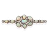 An Opal and Diamond Brooch, the central cluster formed of seven oval cabochon opals spaced by old