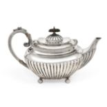 An Edward VII Silver Teapot, by James Dixon and Sons, Sheffield, 1909, oblong and on four ball feet,