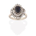 An 18 Carat White Gold Sapphire and Diamond Cluster Ring, the oval cut sapphire within a double