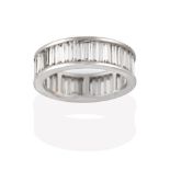 A Diamond Eternity Ring, the baguette cut diamonds in white channel settings, total estimated