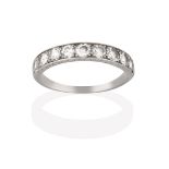 A Diamond Half Hoop Ring, the nine round brilliant cut diamonds in white claw and channel