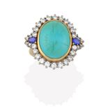 An 18 Carat Gold Turquoise, Sapphire and Diamond Cluster Ring, the oval turquoise cabochon in a