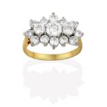 A Diamond Cluster Ring, three graduated round brilliant cut diamonds within an undulating border