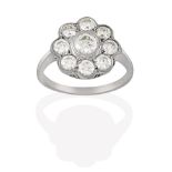 A Diamond Cluster Ring, the round brilliant cut diamond within a border of smaller round brilliant