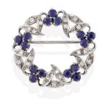 A Sapphire and Diamond Brooch, realistically modelled as a wreath, clusters of three round cut