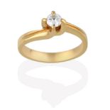 A Diamond Solitaire Ring, the round brilliant cut diamond in a yellow four claw setting, to an