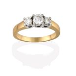 A Diamond Three Stone Ring, the graduated round brilliant cut diamonds in white claw settings, to