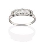 A Diamond Three Stone Ring, the graduated round brilliant cut diamonds in white claw settings, to