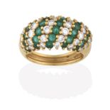 An Emerald and Diamond Ring, formed of eleven alternate rows of round brilliant cut diamonds and