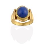 A Synthetic Star Sapphire Ring, the oval cabochon synthetic star sapphire in a yellow rubbed over