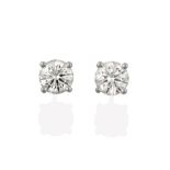 A Pair of 18 Carat White Gold Diamond Solitaire Earrings, the round brilliant cut diamonds in four