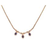 A Sapphire and Diamond Necklace, a central panel formed of three ribbon bow drops composed of oval