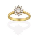 An 18 Carat Gold Diamond Cluster Ring, the central oval cut diamond within a border of round