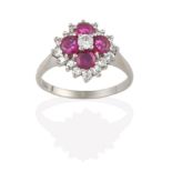 A Ruby and Diamond Cluster Ring, the central round brilliant cut diamond within a border of four